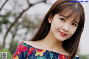 A woman in a floral dress leaning against a wall.