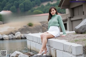 A woman in a white dress posing for a picture.
