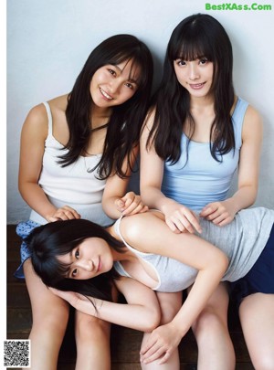 A group of young women eating a strawberry.