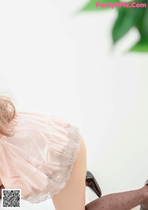 A woman in a pink lingerie posing for a picture.
