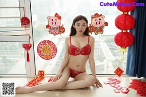 A woman in a red lingerie holding a red fan.