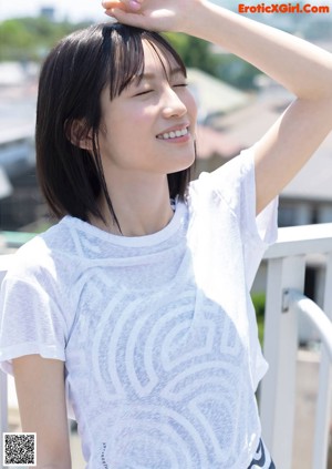 A woman in a purple shirt is posing for a magazine.