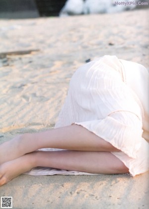 A woman standing in the water at the beach.