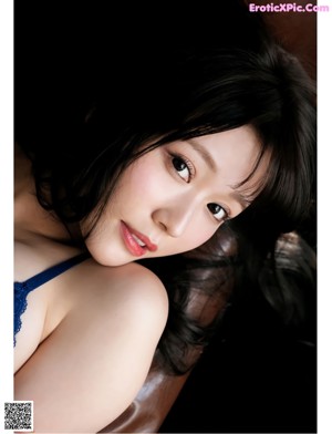 a woman laying on top of a bed wearing a white panties