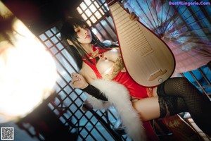 A woman in a red and black outfit playing a musical instrument.