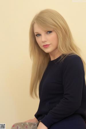 A woman in a black top and jeans sitting on a pink chair.