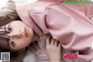A woman in a white shirt and red skirt posing for a magazine.
