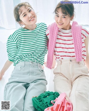 A couple of young women sitting next to each other.