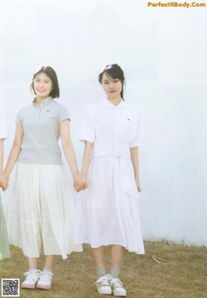A group of young women standing next to each other on a field.