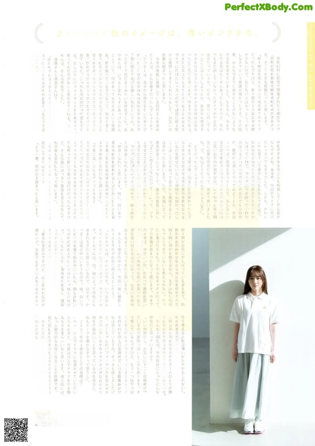 A woman standing in front of a white wall.