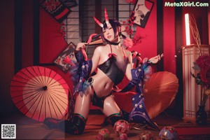 A woman dressed in a kimono is posing for a picture.